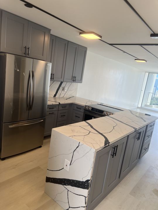 Kitchen with Bold-Vein Quartz Waterfall Island — photo 2
